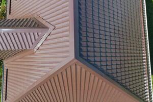 A view from above on the roof of the house. The roof of corrugated sheet. Roofing of metal profile wavy shape photo