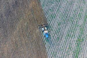 Top view of the tractor that plows the field. disking the soil. Soil cultivation after harvest photo