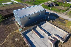 Buildings on the site. Hangar from metal profile, corrugated. Th photo