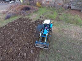 Tractor plowing the garden. Plowing the soil in the garden photo