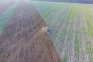 Top view of the tractor that plows the field. disking the soil. Soil cultivation after harvest photo