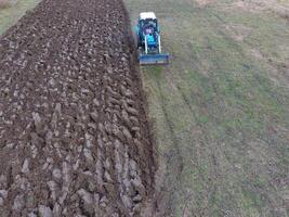 Tractor plowing the garden. Plowing the soil in the garden photo
