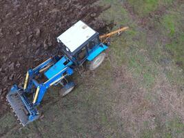 Tractor plowing the garden. Plowing the soil in the garden photo