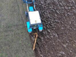 Tractor plowing the garden. Plowing the soil in the garden photo