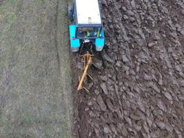 Tractor plowing the garden. Plowing the soil in the garden photo
