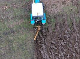 Tractor plowing the garden. Plowing the soil in the garden photo