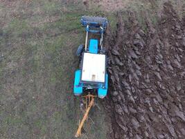 Tractor plowing the garden. Plowing the soil in the garden photo