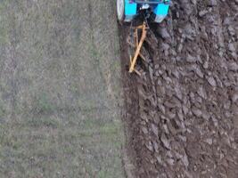 Tractor plowing the garden. Plowing the soil in the garden photo