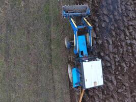 Tractor plowing the garden. Plowing the soil in the garden photo