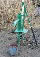 Hand pump leading to an artesian well. photo