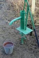 Hand pump leading to an artesian well. photo