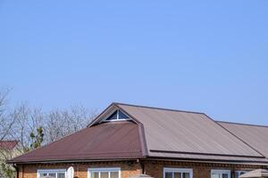 Metal roof brown. Construction of houses and types of roofing. photo