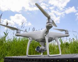 Quadrocopters on a plastic box in the grass photo
