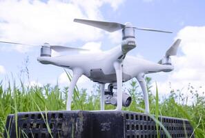 Quadrocopters on a plastic box in the grass photo