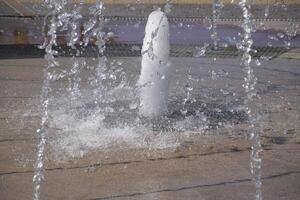 Splashes of a fountain in the park photo