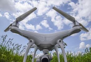 Quadrocopters on a plastic box in the grass photo