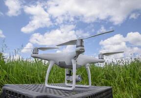Quadrocopters on a plastic box in the grass photo