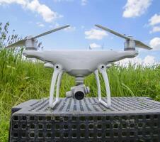 Quadrocopters on a plastic box in the grass photo