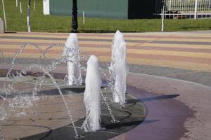 Splashes of a fountain in the park photo