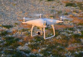 The drone, hovering above the ground photo
