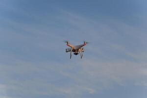 The drone, hovering in the sky. Flight quadrocopters photo