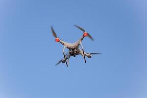 The drone, hovering in the sky. Flight quadrocopters photo