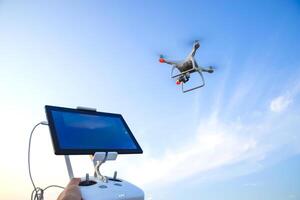 Quadrocopters and a remote control for it. Quadrocopters against the blue sky. Umravlenie quadrocopters photo