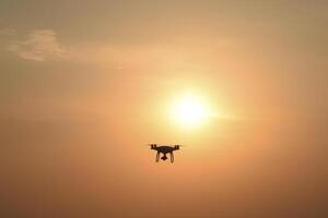 drone silhouette against the background of the sunset photo