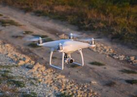 The drone, hovering above the ground photo