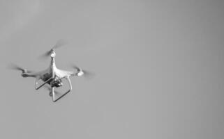 The drone, hovering in the sky. Flight quadrocopters photo