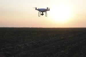 drone silhouette against the background of the sunset photo