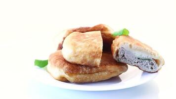 fried pies with meat in a plate on a white background video