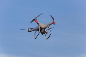The drone, hovering in the sky. Flight quadrocopters photo