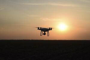 drone silhouette against the background of the sunset photo