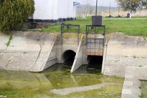 Gateway of a water pumping station. The message of two reservoirs. Hydraulic construction. photo