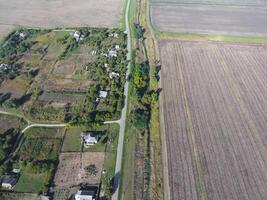 Top view of the village. One can see the roofs of the houses and gardens. Road in the village. Village bird's-eye view photo