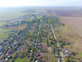 Top view of the village. One can see the roofs of the houses and gardens. Road in the village. Village bird's-eye view photo