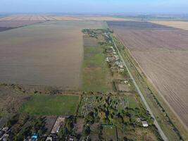 Top view of the village. One can see the roofs of the houses and gardens. Road in the village. Village bird's-eye view photo