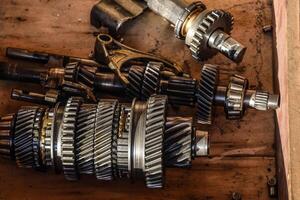 Dismantled box car transmissions. The gears on the shaft of a mechanical transmission photo