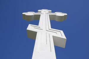 White orthodox christian cross on blue sky background. photo