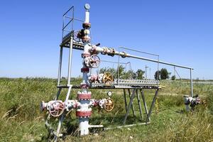 Well for oil and gas production. Oil well wellhead equipment. Oil production photo