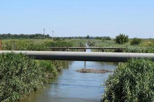 The gas pipeline through the small river photo