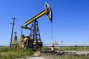 Pumping unit as the oil pump installed on a well photo