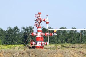 Well for oil and gas production. Oil well wellhead equipment. Oil production photo