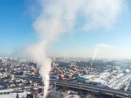 Winter town. Frosty sunny day in the city. Snow on the streets and smoke from the boiler rises. Frost and sun, a wonderful day photo