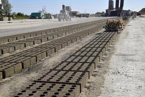 Cinder blocks lie on the ground and dried. on cinder block production plant. photo