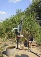 Irrigation system in the home garden. Well with manual and automatic pump. photo