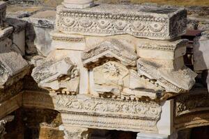 Bas-reliefs of antique scenes on the gables of the amphitheater in Hierapolis, Turkey. photo