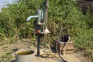 Irrigation system in the home garden. Well with manual and automatic pump. photo