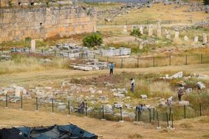 Top view of the excavation site in ruined ancient city of Hierapolis. The remains of destroyed buildings and columns. photo